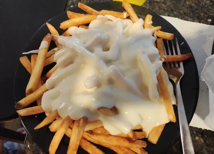 Placeholder photo: french fries covered in melted white cheese sauce